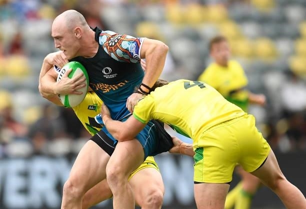 James Turner of Oceania is tackled during the Oceania Sevens Challenge match between Australia and Oceania at Queensland Country Bank Stadium on June...