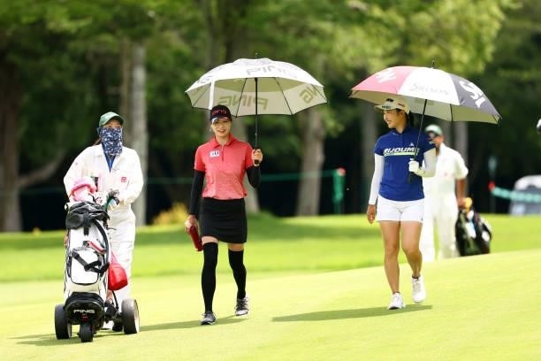 Fumie Tsune and Sakura Koiwai of Japan talk on the 7th fairway during the third round of the Earth Mondamin Cup at Camellia Hills Country Club on...