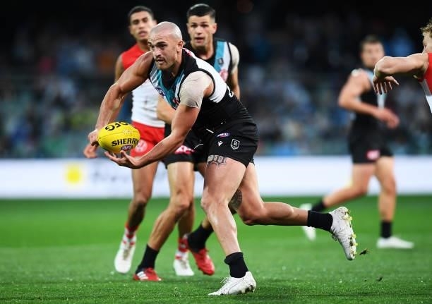 Sam Powell-Pepper of Port Adelaide handballs during the round 15 AFL match between the Port Adelaide Power and the Sydney Swans at Adelaide Oval on...