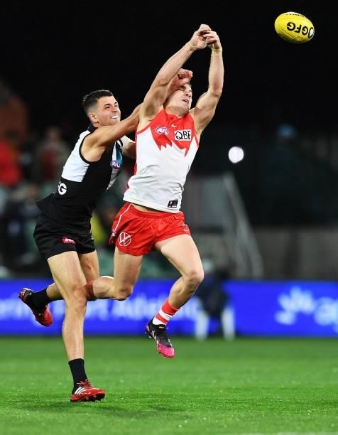 Ryan Burton of Port Adelaide spoils Tom Papley of the Swans during the round 15 AFL match between the Port Adelaide Power and the Sydney Swans at...