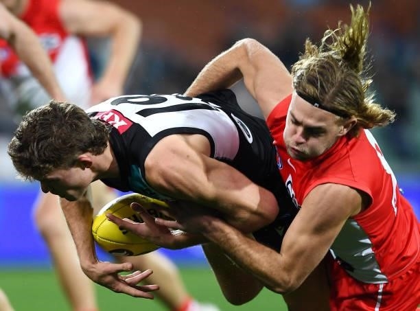 Mitch Georgiades of Port Adelaide tackled by James Rowbottom of the Swans during the round 15 AFL match between the Port Adelaide Power and the...