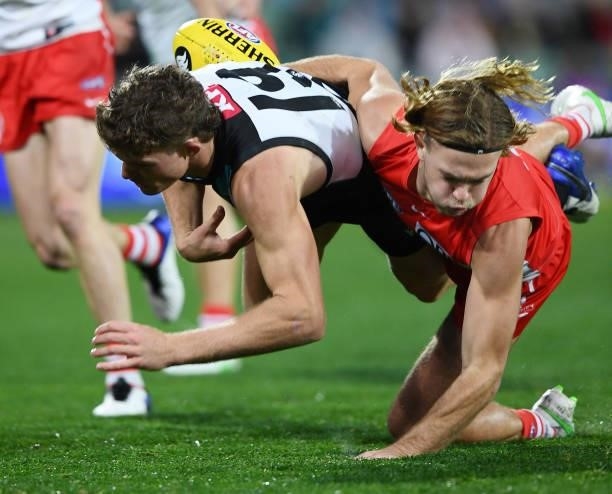 Mitch Georgiades of Port Adelaide tackled by James Rowbottom of the Swans during the round 15 AFL match between the Port Adelaide Power and the...