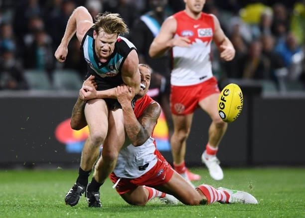 Lance Franklin of the Swans tackles Tom Jonas of Port Adelaide during the round 15 AFL match between the Port Adelaide Power and the Sydney Swans at...