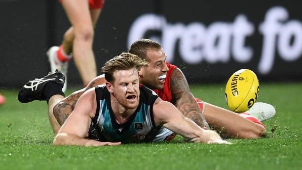 Lance Franklin of the Swans tackles Tom Jonas of Port Adelaide during the round 15 AFL match between the Port Adelaide Power and the Sydney Swans at...