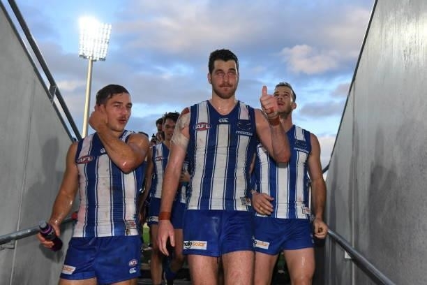 Will Phillips and Tristan Xerri of the Kangaroos leave the field during the round 15 AFL match between the North Melbourne Kangaroos and the Gold...
