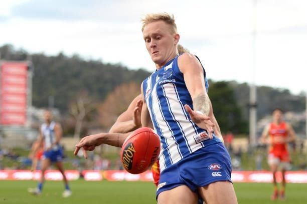 Jaidyn Stephenson of the Kangaroos kicks the ball during the round 15 AFL match between the North Melbourne Kangaroos and the Gold Coast Suns at...