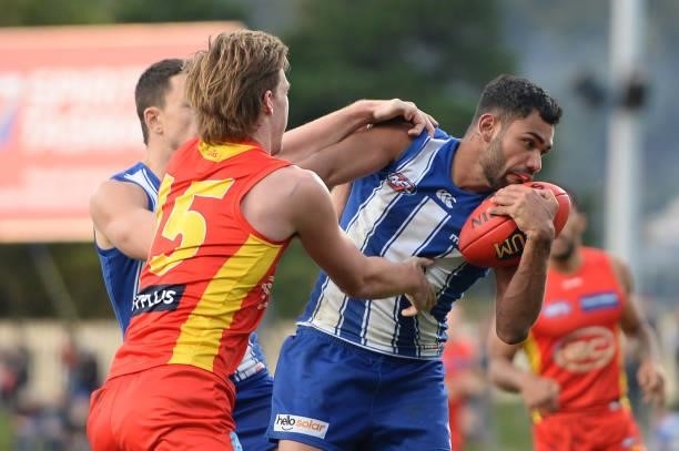 Tarryn Thomas of the Kangaroos is tackled by Noah Anderson of the Suns during the round 15 AFL match between the North Melbourne Kangaroos and the...