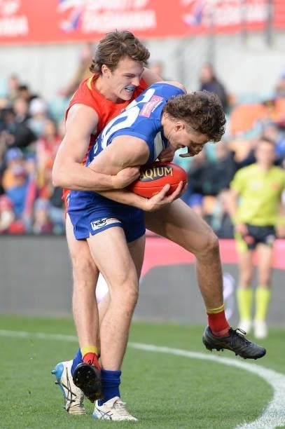 Nick Larkey of the Kangaroos is tackled by Noah Anderson of the Suns during the round 15 AFL match between the North Melbourne Kangaroos and the Gold...