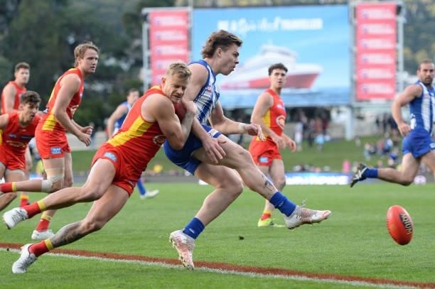 Cameron Zurhaar of the Kangaroos is tackled by Brandon Ellis of the Suns during the round 15 AFL match between the North Melbourne Kangaroos and the...