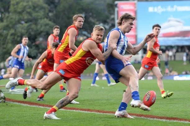 Cameron Zurhaar of the Kangaroos is tackled by Brandon Ellis of the Suns during the round 15 AFL match between the North Melbourne Kangaroos and the...