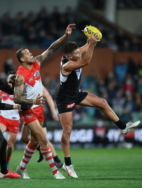 Karl Amon of Port Adelaide marks in front of Lance Franklin of the Swans during the round 15 AFL match between the Port Adelaide Power and the Sydney...