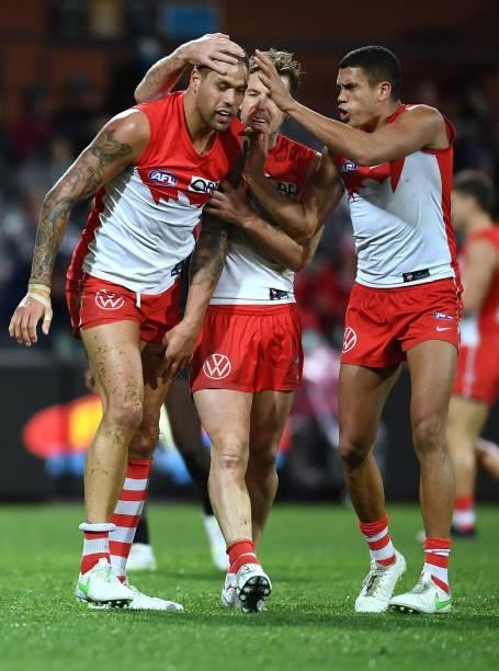Lance Franklin of the Swans celebrates a tackle of Tom Jonas of Port Adelaide with Luke Parker and James Bell of the Swans during the round 15 AFL...