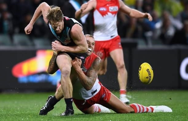 Lance Franklin of the Swans gts Tom Jonas of Port Adelaide caught holding the ball during the round 15 AFL match between the Port Adelaide Power and...