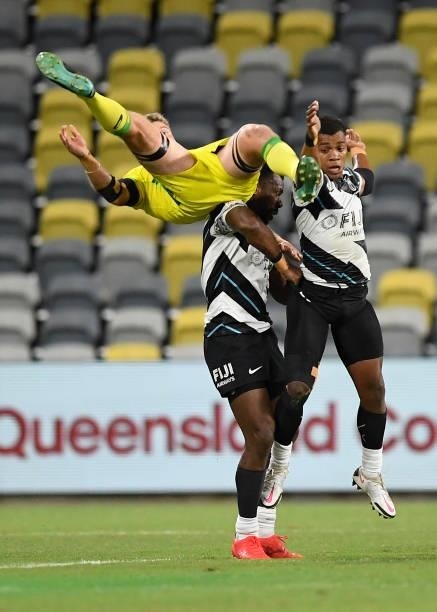 Nick Malouf of Australia contest the ball with Napolioni Bolaca and Kavekini Tabu of Fiji during the Oceania Sevens Challenge match between Fiji and...