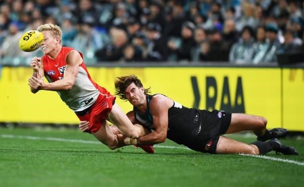 Isaac Heeney of the Swans tackled by Scott Lycett of Port Adelaide during the round 15 AFL match between the Port Adelaide Power and the Sydney Swans...