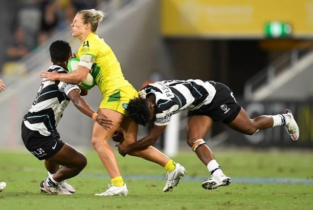 Emma Tonegato of Australia is tackled during the Oceania Sevens Challenge match between Australia and Fiji at Queensland Country Bank Stadium on June...