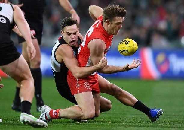 Luke Parker of the Swans tackled by Karl Amon of Port Adelaide during the round 15 AFL match between the Port Adelaide Power and the Sydney Swans at...