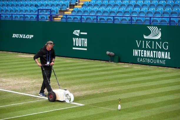 Ground staff prep center court ahead of the final round of matchs during day 8 of the Viking International Eastbourne at Devonshire Park on June 26,...