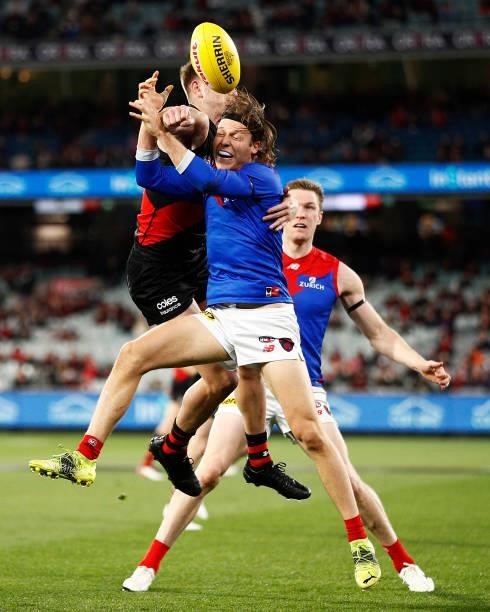 Ed Langdon of the Demons and Jayden Laverde of the Bombers contest the ball during the round 15 AFL match between the Essendon Bombers and the...