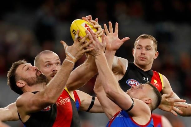 Cale Hooker of the Bombers and Steven May of the Demons compete for the ball during the round 15 AFL match between the Essendon Bombers and the...