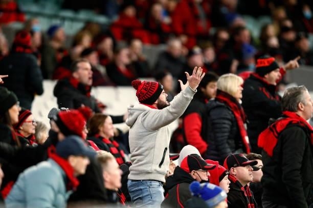 Essendon fans react during the round 15 AFL match between the Essendon Bombers and the Melbourne Demons at Melbourne Cricket Ground on June 26, 2021...