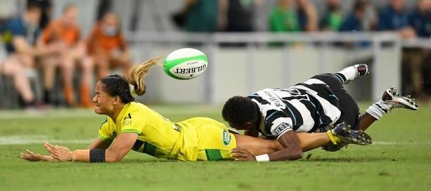 Faith Nathan of Australia is tackled by Reapi Ulunasau of Fiji during the Oceania Sevens Challenge match between Australia and Fiji at Queensland...