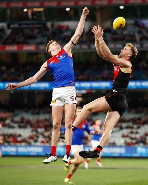 James Stewart of the Bombers and Bayley Fritsch of the Demons contest the ball during the round 15 AFL match between the Essendon Bombers and the...