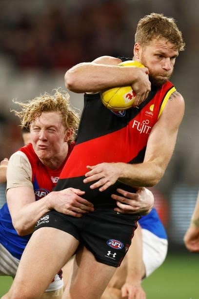 Jake Stringer of the Bombers is tackled by Clayton Oliver of the Demons during the round 15 AFL match between the Essendon Bombers and the Melbourne...