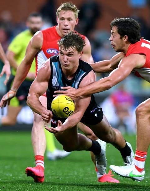 Ollie Wines of Port Adelaide handballs during the round 15 AFL match between the Port Adelaide Power and the Sydney Swans at Adelaide Oval on June...