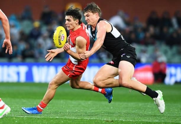 Kaiden Brand of the Swans tackled by Ollie Wines of Port Adelaide during the round 15 AFL match between the Port Adelaide Power and the Sydney Swans...