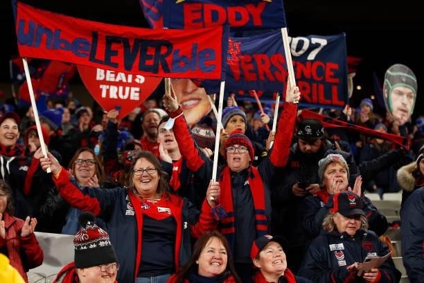 Demons fans sin the team song after the round 15 AFL match between the Essendon Bombers and the Melbourne Demons at Melbourne Cricket Ground on June...
