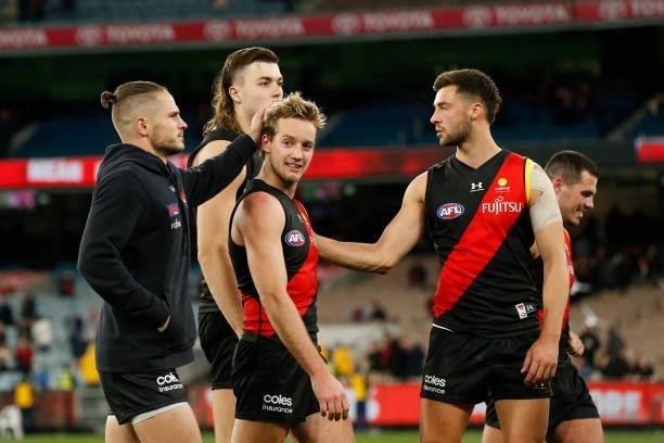 Dejected Essendon players walk from the ground after the round 15 AFL match between the Essendon Bombers and the Melbourne Demons at Melbourne...