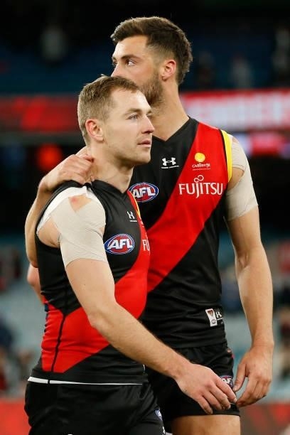Devin Smith and Kyle Langford of the Bombers walks from the ground after the round 15 AFL match between the Essendon Bombers and the Melbourne Demons...