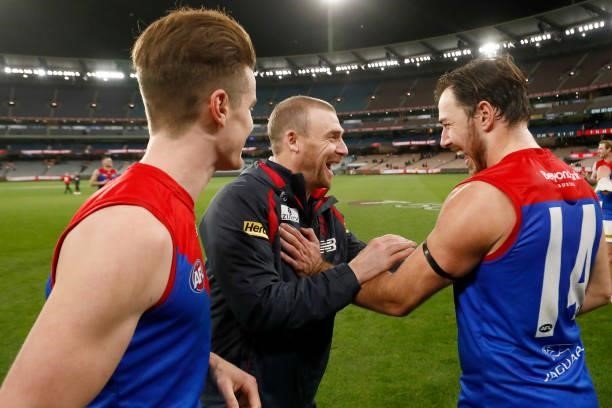 Simon Goodwin, Senior Coach of the Demons shares a laugh with Michael Hibberd after the round 15 AFL match between the Essendon Bombers and the...