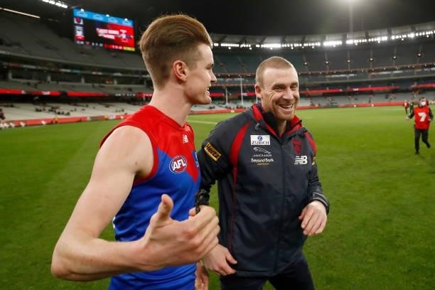 Bayley Frisch and Simon Goodwin, Senior Coach of the Demons embrace after the round 15 AFL match between the Essendon Bombers and the Melbourne...