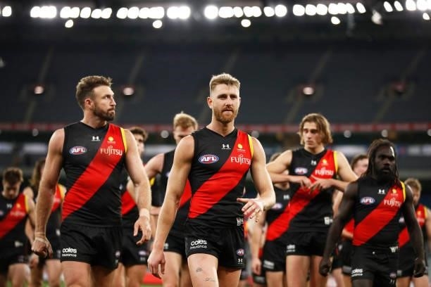 Dyson Heppell of the Bombers leads the Bombers off the field after the round 15 AFL match between the Essendon Bombers and the Melbourne Demons at...