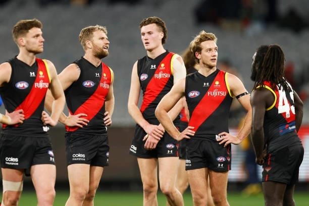 Bombers players look dejected after the round 15 AFL match between the Essendon Bombers and the Melbourne Demons at Melbourne Cricket Ground on June...