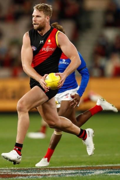 Jake Stringer of the Bombers runs with the ball during the round 15 AFL match between the Essendon Bombers and the Melbourne Demons at Melbourne...