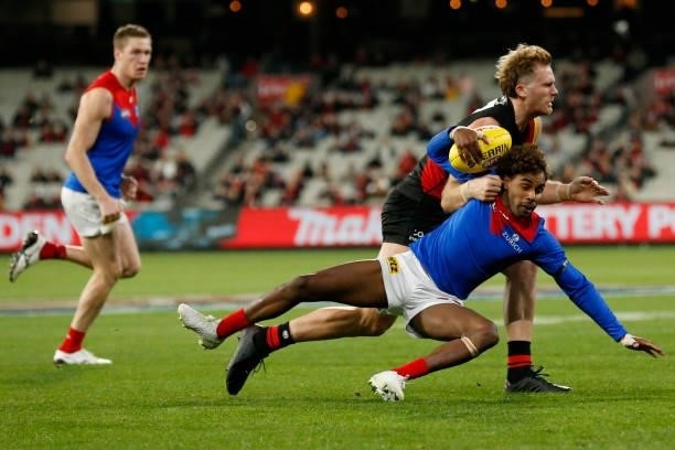 James Stewart of the Bombers tackles Kysaiah Pickett of the Demons during the round 15 AFL match between the Essendon Bombers and the Melbourne...