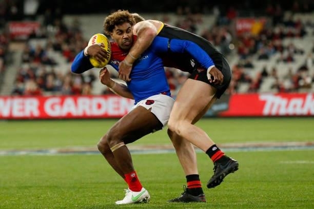James Stewart of the Bombers tackles Kysaiah Pickett of the Demons during the round 15 AFL match between the Essendon Bombers and the Melbourne...