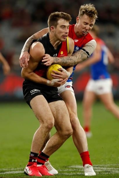 Zach Merrett of the Bombers and James Harmes of the Demons collide in a marking contest during the round 15 AFL match between the Essendon Bombers...