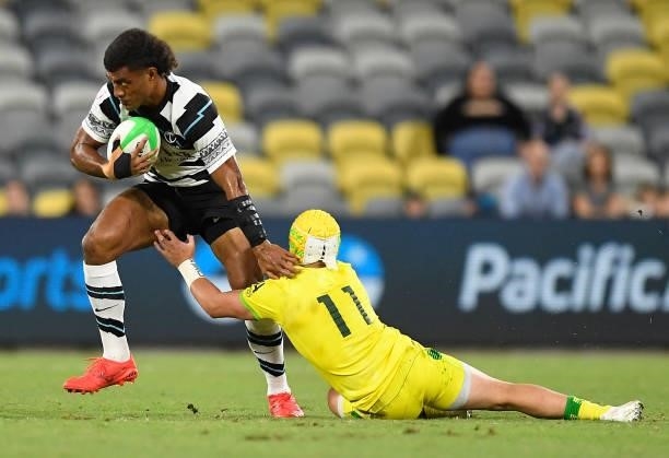 Taniela Sadrugu of Fiji is tackled by Josh Coward of Australia during the Oceania Sevens Challenge match between Fiji and Australia at Queensland...