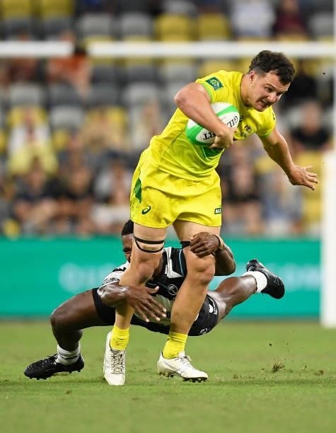 Dylan Pietsch of Australia is tackled during the Oceania Sevens Challenge match between Fiji and Australia at Queensland Country Bank Stadium on June...