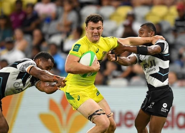 Dylan Pietsch of Australia is tackled during the Oceania Sevens Challenge match between Fiji and Australia at Queensland Country Bank Stadium on June...