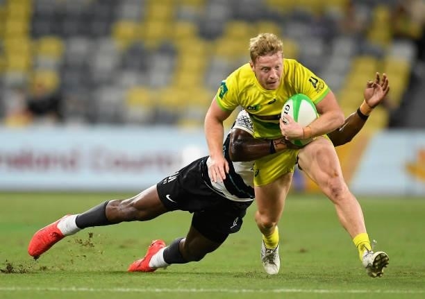 Lachlan Miller of Australia is tackled during the Oceania Sevens Challenge match between Fiji and Australia at Queensland Country Bank Stadium on...