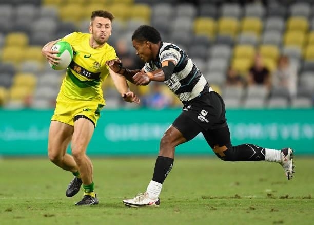 Josh Turner of Australia is tackled during the Oceania Sevens Challenge match between Fiji and Australia at Queensland Country Bank Stadium on June...