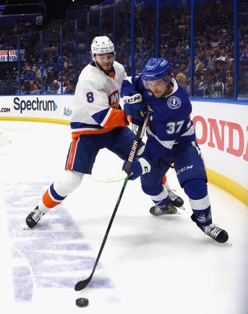 Noah Dobson of the New York Islanders skates against Yanni Gourde of the Tampa Bay Lightning in Game Seven of the NHL Stanley Cup Semifinals during...