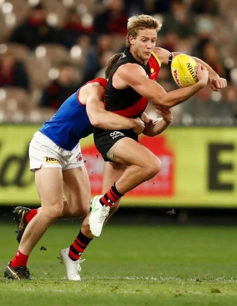 Darcy Parish of the Bombers handballs during the round 15 AFL match between the Essendon Bombers and the Melbourne Demons at Melbourne Cricket Ground...