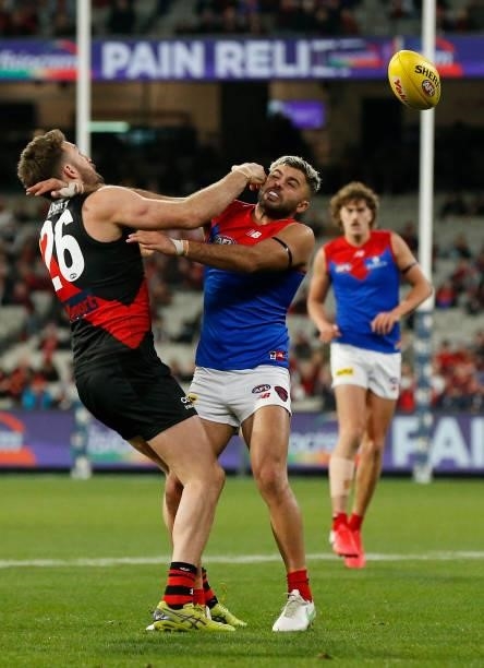 Cale Hooker of the Bombers and Christian Salem of the Demons compete for the ball during the round 15 AFL match between the Essendon Bombers and the...