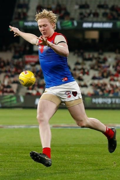 Clayton Oliver of the Demons kicks the ball during the round 15 AFL match between the Essendon Bombers and the Melbourne Demons at Melbourne Cricket...